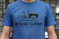 Person wearing a blue t-shirt with a Let's Go Cargo! graphic.